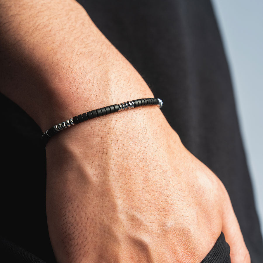 Our Black Onyx & Silver Bead Bracelet features black onyx and polished geometric stainless steel beads, finished off with our signature 'RG&B' engraved bead.